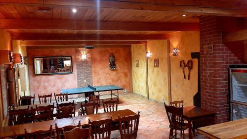 a dining room with tables and chairs in a restaurant at Penzion Oliver in Žacléř