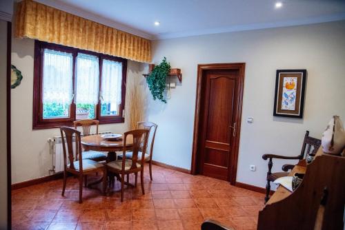 a dining room with a table and chairs at La Mies in Rasines
