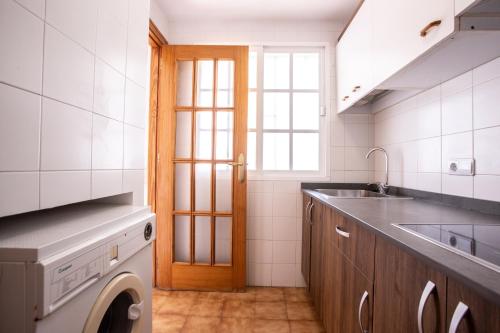 a kitchen with a sink and a washing machine at Vistamojacar in Mojácar