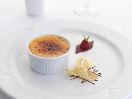 a cup of coffee on a plate with a dessert at Fernhill Hotel in Portpatrick