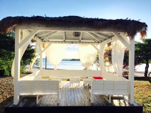 a white gazebo with a straw roof at Apartment Mirella in Umag
