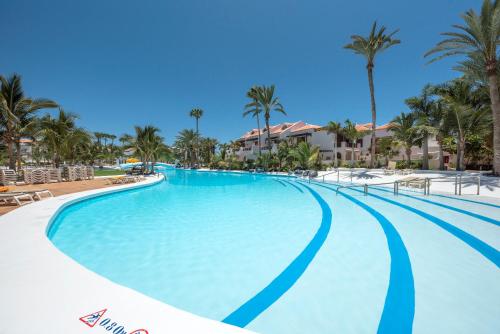 a large swimming pool at a resort with palm trees at Parque Santiago 3 Luxery Apartment, Playa las Américas, Arona, Tenerife in Playa de las Americas
