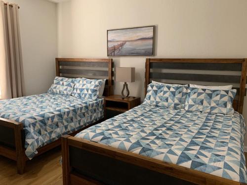 a bedroom with two beds and a picture on the wall at 205 - Disney, Universal, Convention Center in Orlando