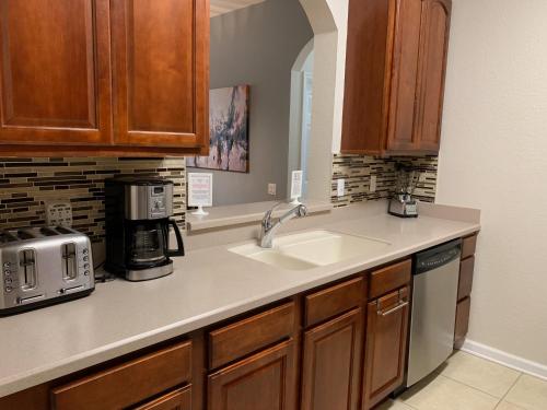 a kitchen with a sink and a microwave at 205 - Disney, Universal, Convention Center in Orlando