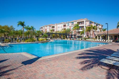 a large swimming pool with palm trees and buildings at 205 - Disney, Universal, Convention Center in Orlando