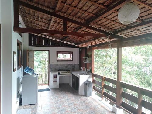 a kitchen with a stove top oven in a house at Treetop Guesthouse and Bungalows in Sabang