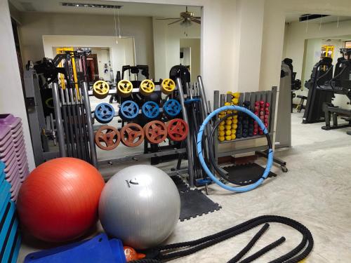 a gym with exercise equipment and a ball and balls at โฮมสเตย์ เมืองไทยฟิตเนส อารีนา in Ban Bo Nam