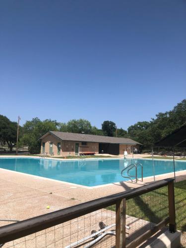 a large swimming pool with a fence around it at CYC Eclectic Escape in San Antonio