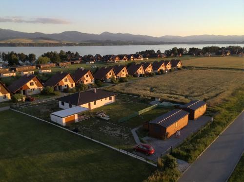 an aerial view of a village with houses and a lake at Amis apartmán 1 in Liptovský Mikuláš