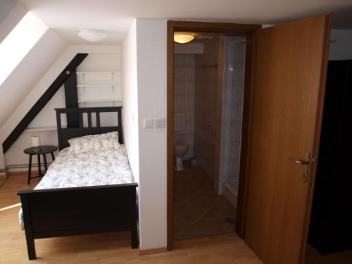 a bedroom with a bed and a glass door at Samostan Mekinje in Kamnik