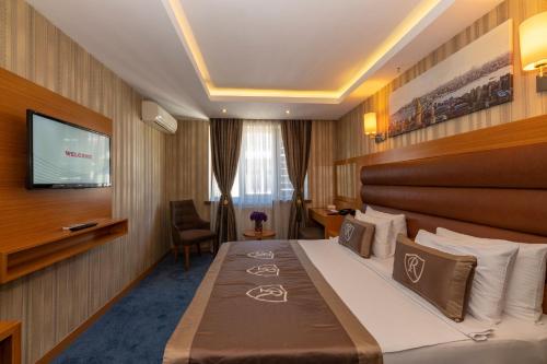 a hotel room with a bed and a television at Regno Hotel in Istanbul