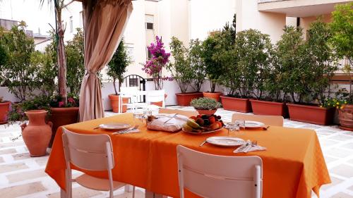 a table with an orange table cloth on a patio at Mediterraneo B&B in Maglie