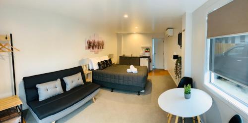 a living room with a couch and a table at Racecourse Motel in Paeroa