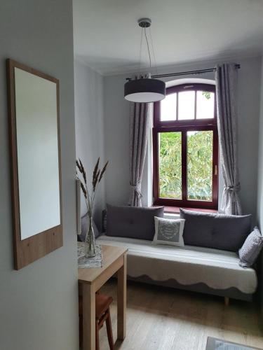 a living room with a couch and a window at Pokoje Gościnne Świnoujście Łunowo in Świnoujście