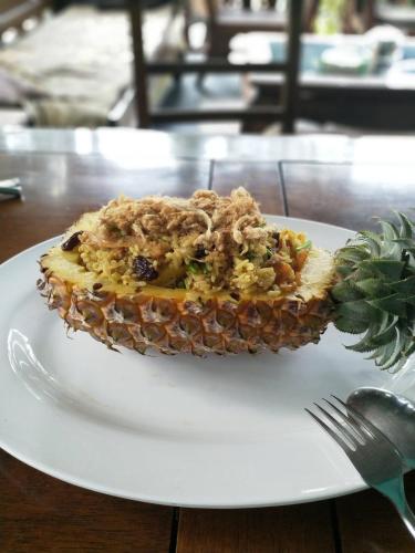a piece of food on a white plate on a table at Kuba Bungalows in Ko Kood