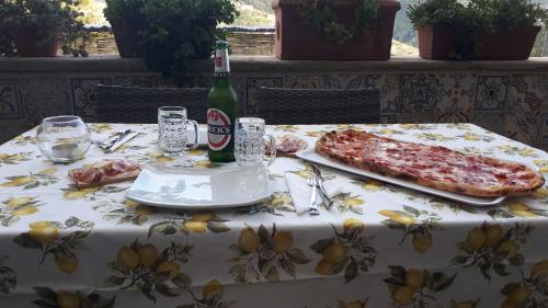 a table with two slices of pizza and a bottle of beer at Hill Valley View in Vico Equense