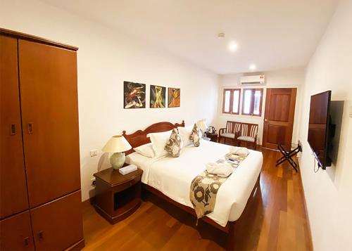 a bedroom with a bed and a television in it at Heeren Straits Hotel in Melaka