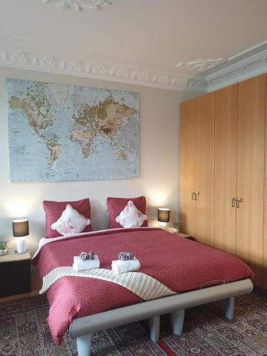 a bedroom with a large bed with a map on the wall at Antonius Bed and Breakfast in Arnhem