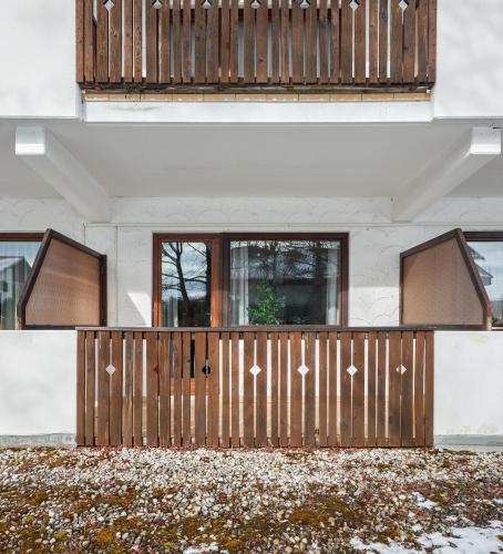 a wooden gate in front of a house at Landhotelwohnung in Seeg in Seeg