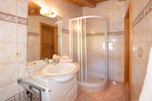 a bathroom with a sink and a shower at Ferienhaus Schafstall in Alpbach