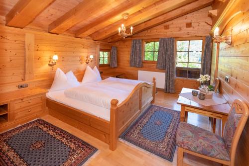 a bedroom with a bed in a log cabin at Ferienhaus Schafstall in Alpbach