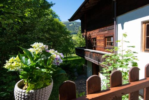 a balcony of a house with flowers on it at Ferienhaus Schafstall in Alpbach