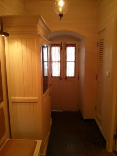 a hallway of a home with a door and windows at Welcomhotel by ITC Hotels, The Savoy, Mussoorie in Mussoorie