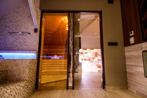 an open glass door in a room with a staircase at Apartments Marconio Wellness Club in Belgrade