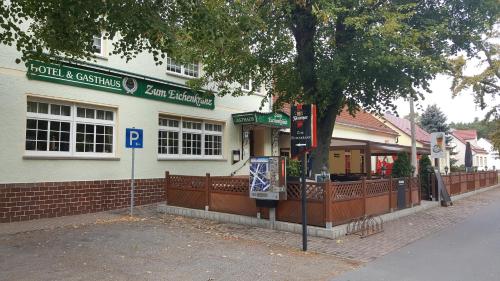 a building with a parking sign in front of it at Hotel & Gasthaus Zum Eichenkranz in Luckenwalde