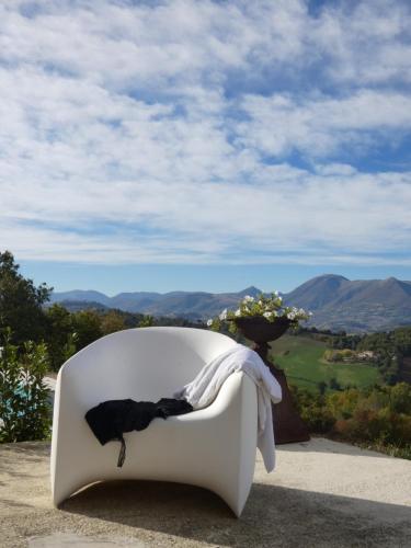 a white chair with a black cat sitting on it at Borgo Crispiero in Crispiero