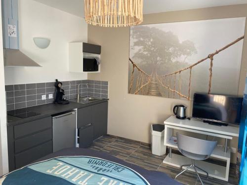 a small kitchen with a bridge painting on the wall at Tahoe in La Grande-Motte