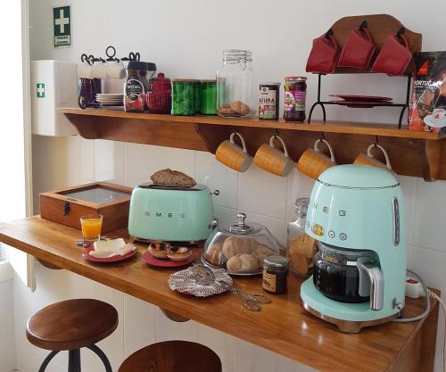 a kitchen counter with a mixer and some food at Cork Train Station Guesthouse in Esmoriz