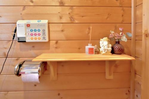 a shelf on a wall with a sewing machine at Carrefour Guesthouse カルフール ゲストハウス in Yokamachi