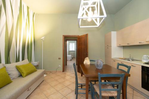 a living room and kitchen with a table and a couch at Villa Barbara in Santa Luce