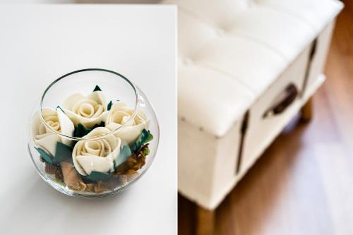 a vase filled with flowers sitting on a counter at Marcus Suite in Cagliari
