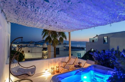a hot tub on the roof of a house at Honey & Cinnamon Luxury Suite in Naxos Chora