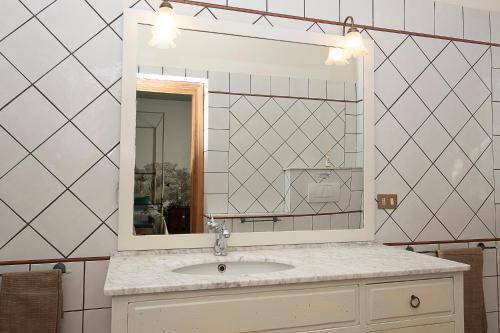 a bathroom with a sink and a mirror at Villa Barbara in Santa Luce