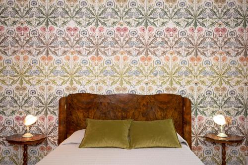 a bedroom with a bed with two nightstands and two lamps at Villa Barbara in Santa Luce