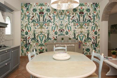 a dining room with a table and a patterned wall at Villa Barbara in Santa Luce