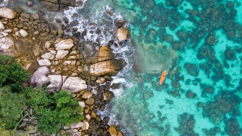 an aerial view of the ocean and the rocks at Wapi Resort in Ko Lipe