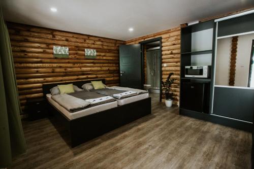 a bedroom with a bed and a wooden wall at Siocamping in Siófok