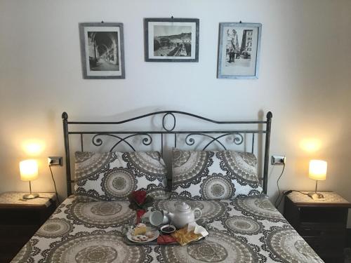 a bedroom with a bed with a tea set on it at B&B Lercari in Genoa