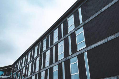 a black building with windows on the side of it at Hotel Brandan in Tórshavn