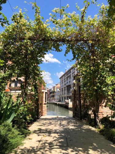 a bridge over a canal in a city at Madama Garden Retreat in Venice