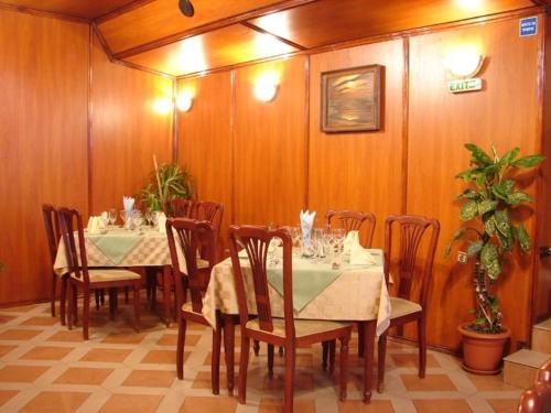 a dining room with a table and chairs in a room at Darling Hotel in Sofia