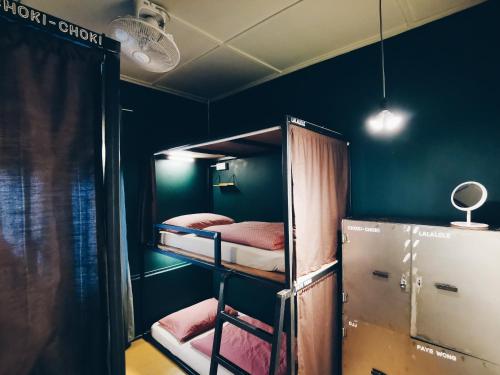a room with two bunk beds and a refrigerator at Heahtitude - Children Not Allowed in Cameron Highlands