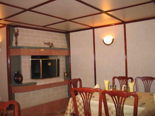 a dining room with a table and a fireplace at Darling Hotel in Sofia
