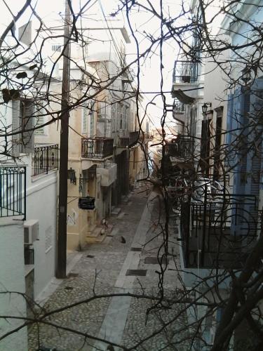an alley in a city with buildings at HERMOUPOLI ROOMS in Ermoupoli