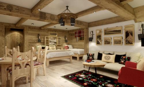 Un dormitorio con dos camas y una mesa y sillas. en Przystań w Tatrach - Przytulne Domki i Apartamenty-Luxury Chalets and Apartments, en Bukowina Tatrzańska