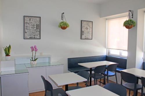 a restaurant with tables and chairs and a window at Vivacity Porto - Rooms & Apartments in Porto